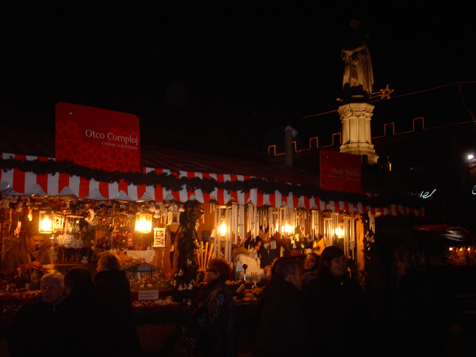 Lit stalls on Bolzano's square at night