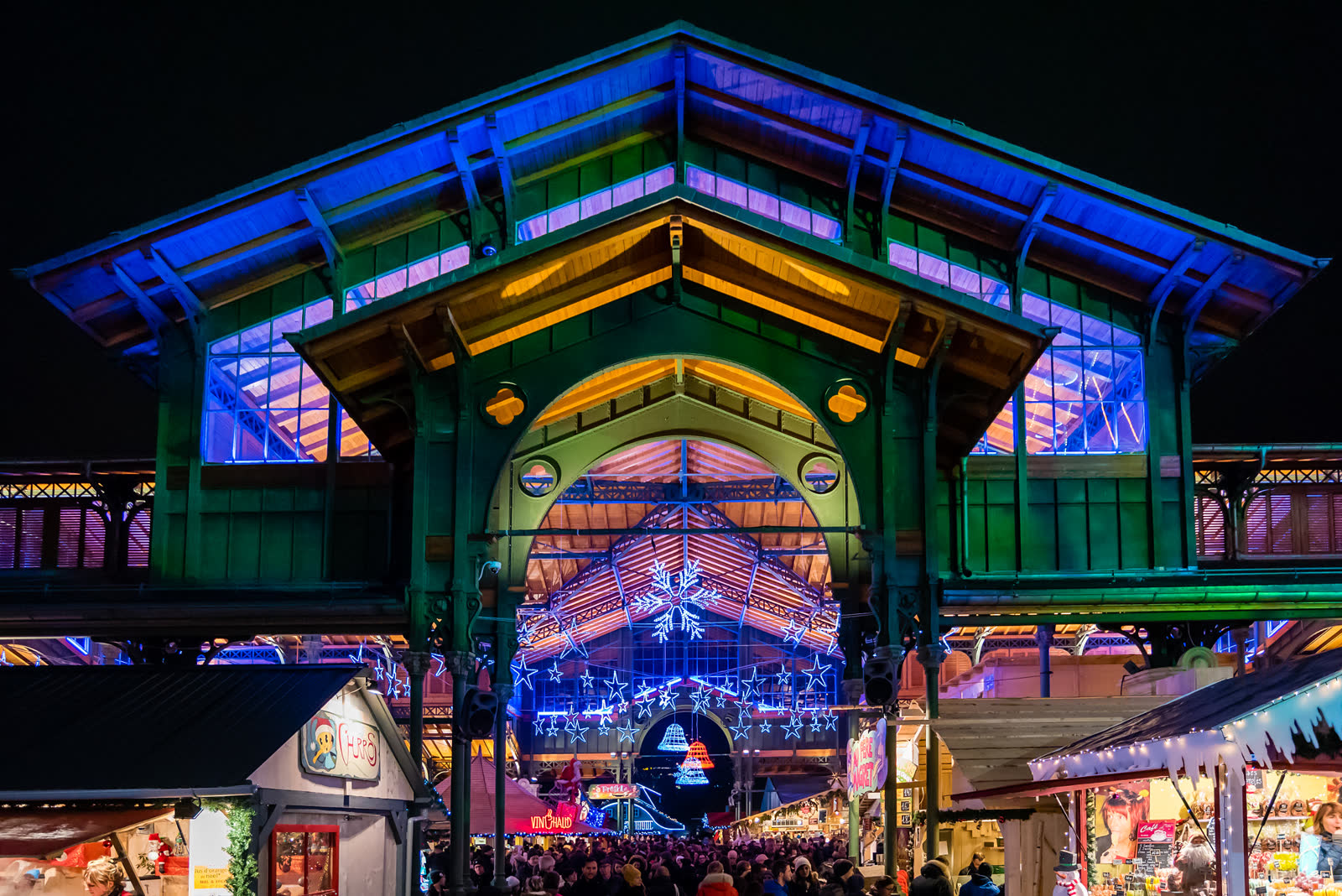 The covered market hall in Montreux lit up at night during the Christmas market